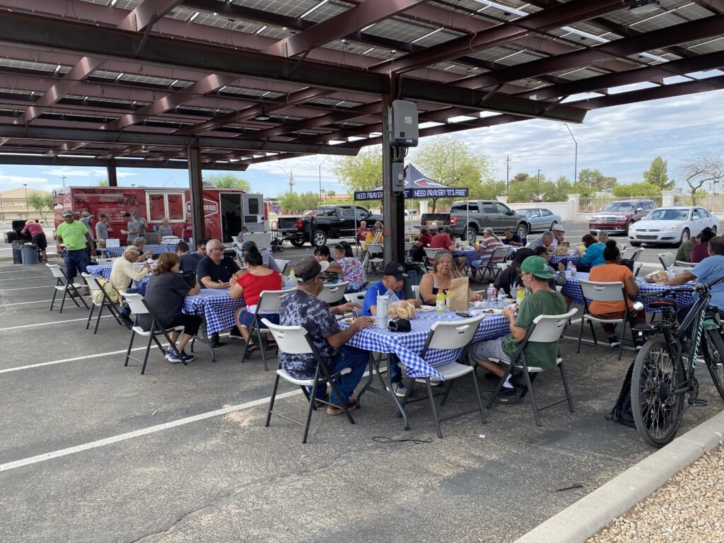 Neighbors sharing the free Wednesday BBQ lunch at the church