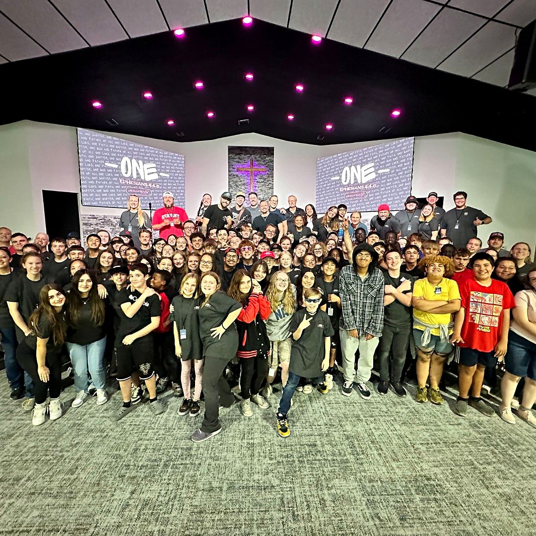 A large group of students in a worship room