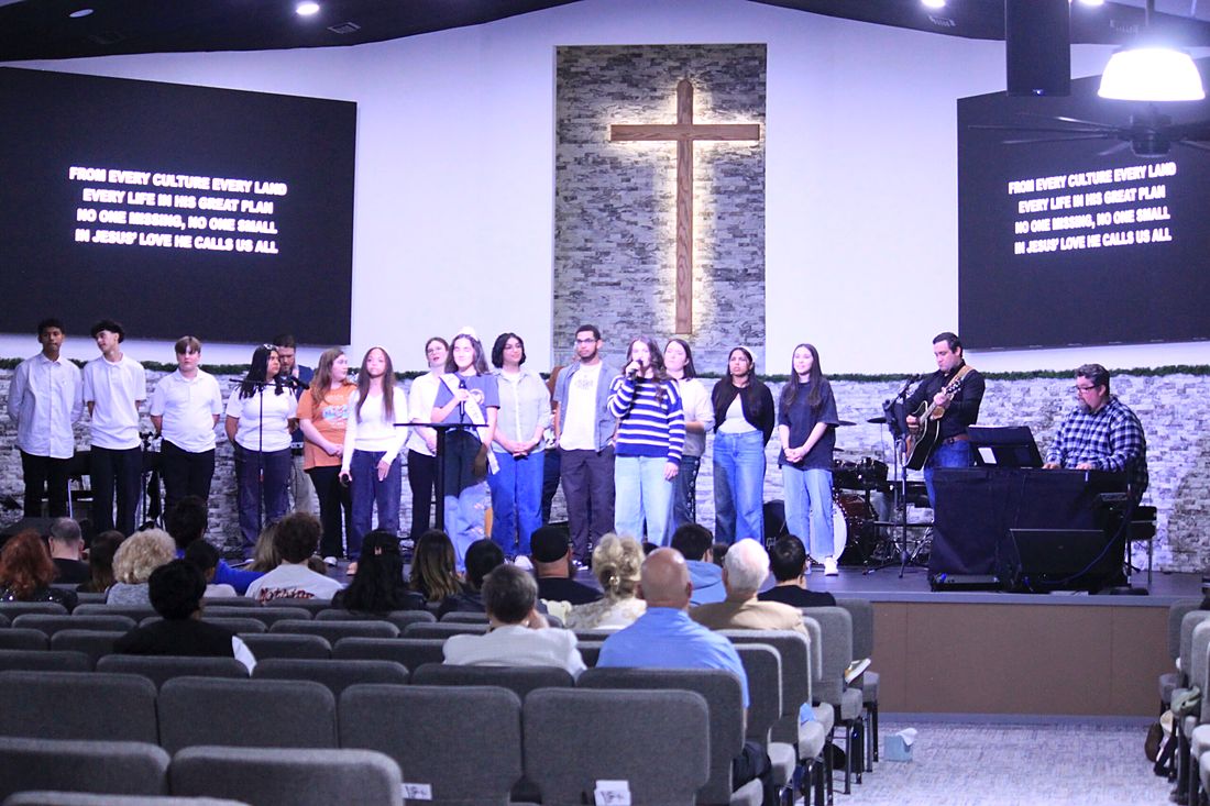 Singers and musicians on the Worship Center stage under the cross